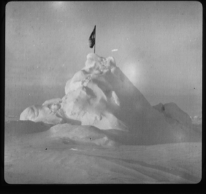 Image of U.S. flag atop a snow pile